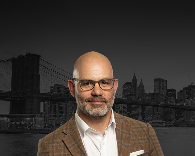 Attorney Jeremy Saland, Esq. with a city in the background